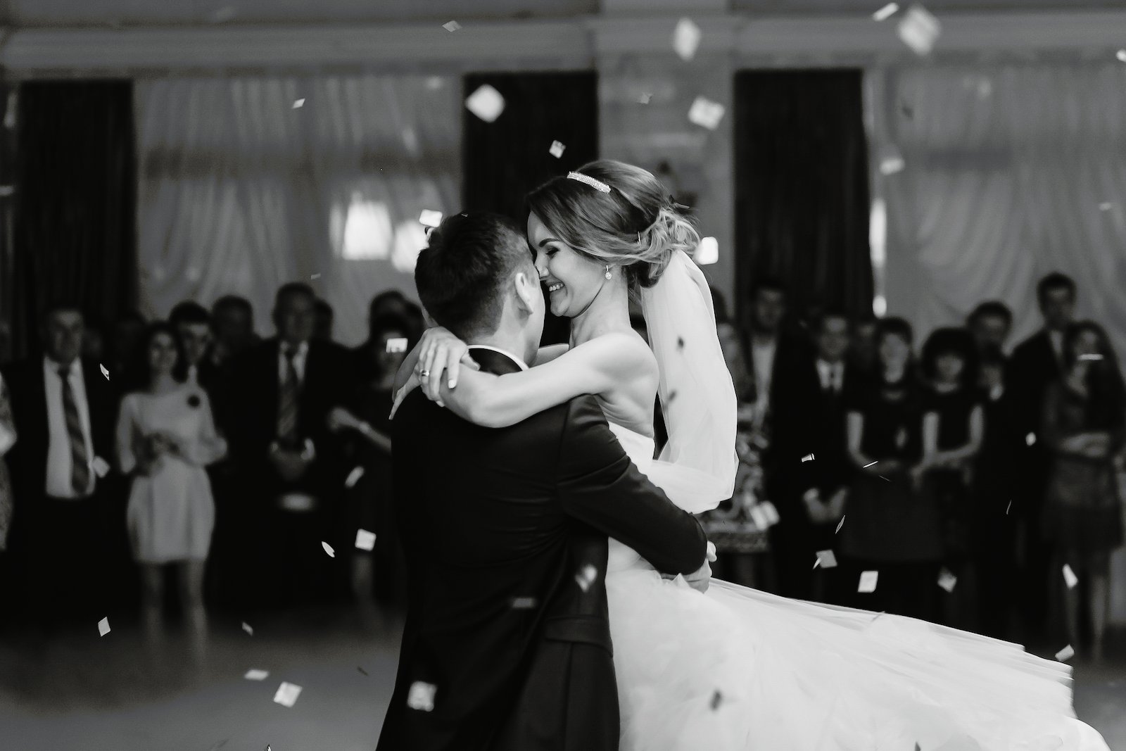 Bride hugs fiance while dancing in the restaurant
